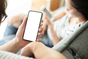 Mockup image blank white screen cell phone.man hand holding texting using mobile.background empty...