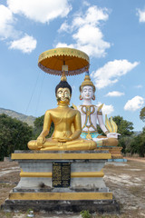 Meditation Buddha statue under blue sky with trees around
