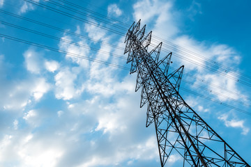 High voltage pole power transmission tower with blue sky