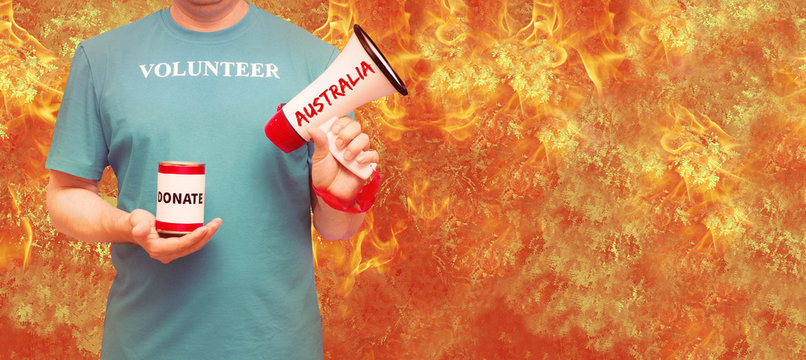 A Man In A Blue T-shirt With The Inscription Volunteer. Fire, Firefighter,donate, Climate Change, Australia. The Concept Of Volunteering Around The World.