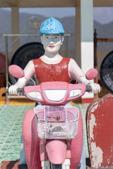 man on red motorcycle statue