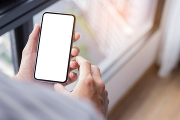 Mockup image blank white screen cell phone.woman hand holding texting using mobile background empty space for advertise text.people contact marketing business,technology 