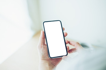 Mockup image blank white screen cell phone.man hand holding texting using mobilebackground empty space for advertise text.people contact marketing business,technology 