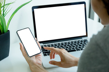 mockup image blank screen computer,cell phone with white background for advertising text,hand man using laptop texting mobile contact business search information on desk in office.marketing,design