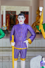 Angle statue holding arm at the temple