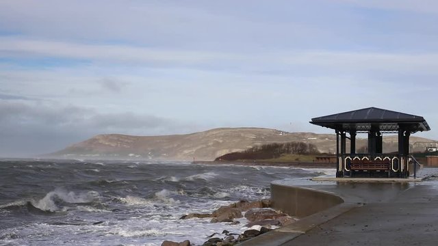 A British Victorian Beach Shelter In A Storm
