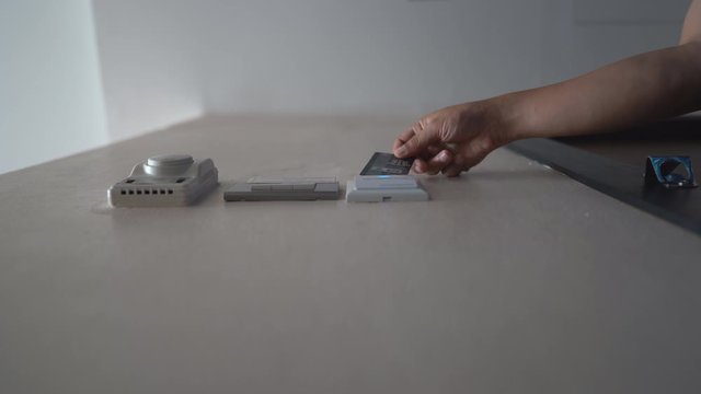 Down view hand holding key card insert box card for open and close system in room