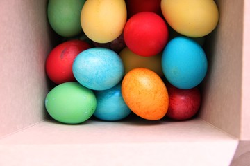 lots of multi-colored Easter eggs in a white square box. Easter preparations. Painting eggs. painted eggs. tinting.