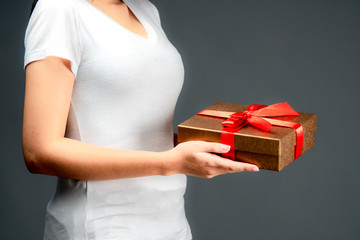 Women hands holding a gift box, birthday or New Year eve celebrating concept.