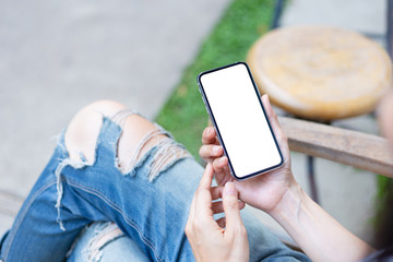 Mockup image blank white screen cell phone.man hand holding texting using mobile sitting at coffee shop.background empty space for advertise text.people contact marketing business,technology 