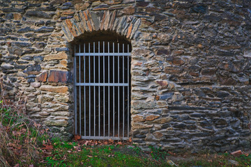 Fototapeta na wymiar Barred door on a tower of an old castle