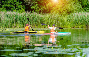 Two men floating in a canoe on the river