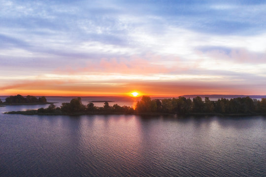 Beautiful sunrise over river with an island