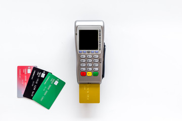 Pay by credit card in shop. Terminal and card on white background top-down copy space