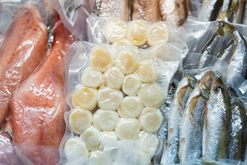 Frozen fish in a commercial freezer. Different river fish, fish cakes, sea bass