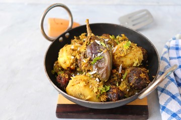 Food - Traditional Indian Gujarati dish Surti Undhiyu. Its a mixed vegetable dish cooked with stuffed brinjals, fried potatoes, Methi Muthia, purple yam, Papadi and spices. Makar Sankranti Special.