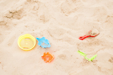 Fototapeta na wymiar Beach toys lying in the sand