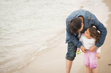 Father and daughter enjoying a day at the beach together.