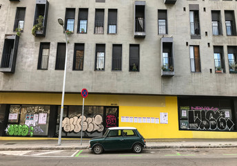 BARCELONA, SPAIN - FEBRUARY 29, 2019 : Green mini cooper old car parked in the street of Barcelona.