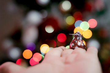 Chocolate is wrapped in an inverted cone shape. Against the bokeh background
