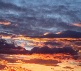 Sunrise clouds. Dramatic magical sunset over orange cloudy sky