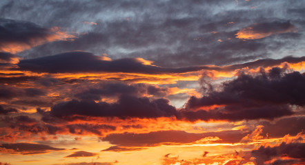 Sunrise clouds. Dramatic magical sunset over orange cloudy sky