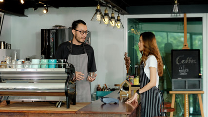 Asia small business owner, Happy asian man, woman barista, waiter, waitress talking in font of coffee shop cafe counter, Male and female partnership in start up new food and drink industry
