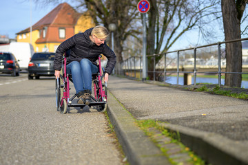 Blond woman manoeuvring a wheelchair