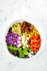 Vegetarian buddha bowl. Raw vegetables, tofu and bulgur in white bowl. Vegetarian, healthy, detox food concept