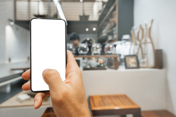 Mockup image Screen layout of the smartphone phone in the hands of a man in a cafe interior.