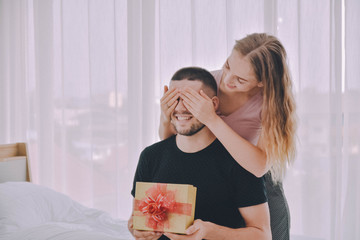 Love Couple giving gift box in bedroom happiness in love Valentine's day concept