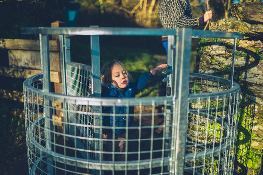 Little toddler in a turnstile gate