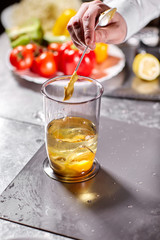 The chef adds mustard. Beating of homemade mayonnaise with olive oil. Mix ingredients for sauce. The chef uses a blender. Step by step sauce preparation