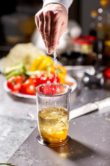 The chief salts. Beating of homemade mayonnaise with olive oil. Mix ingredients for sauce. The chef uses a blender. Step by step sauce preparation