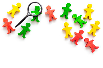 Multinationality concept. Socail research. People cutouts under magnifier on white background...