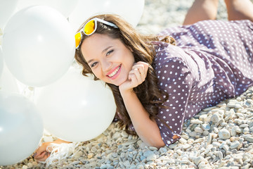 Plus size model posing with white balloons.