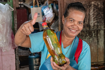 elderly Asian women and used oil