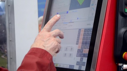 Person works behind the control panel of the production machine