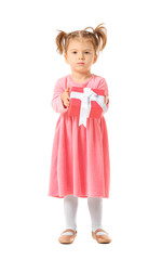 Cute little girl with gift box on white background