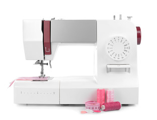 Modern sewing machine on white background