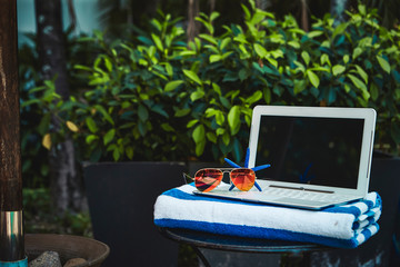 Summer vacation, star fish, sunglasses and laptop 