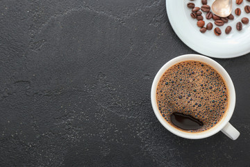 Cup of hot coffee on grey background