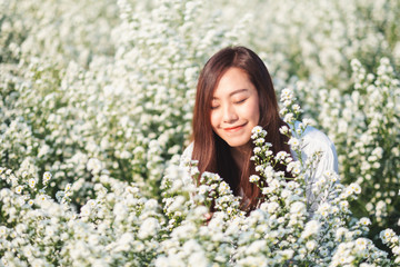 Fototapeta premium Portrait image of an asian woman in a beautiful Cutter flower field