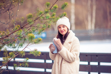 Smiling young girl skating on ice rink outdoors