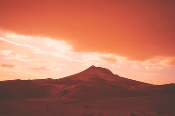 Mountainous desert with dramatic evening cloudy sky at sunset. The Judean Desert in Israel