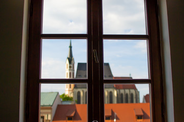 Defocused image of the facade of St. Vitus Church through a window from inside of a house in Cesky Krumlov, Czech Republic