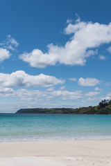 Obraz premium white clouds over beach in Tasmania