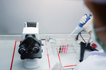 Cropped shot view of  the equipment and science experiments in Laboratory, Chemical substances for research and analyzing a sample under the microscope in laboratory.   