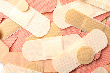 Different medical sticking plasters as background, closeup. First aid item