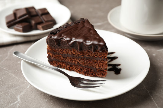 Tasty chocolate cake served on grey table